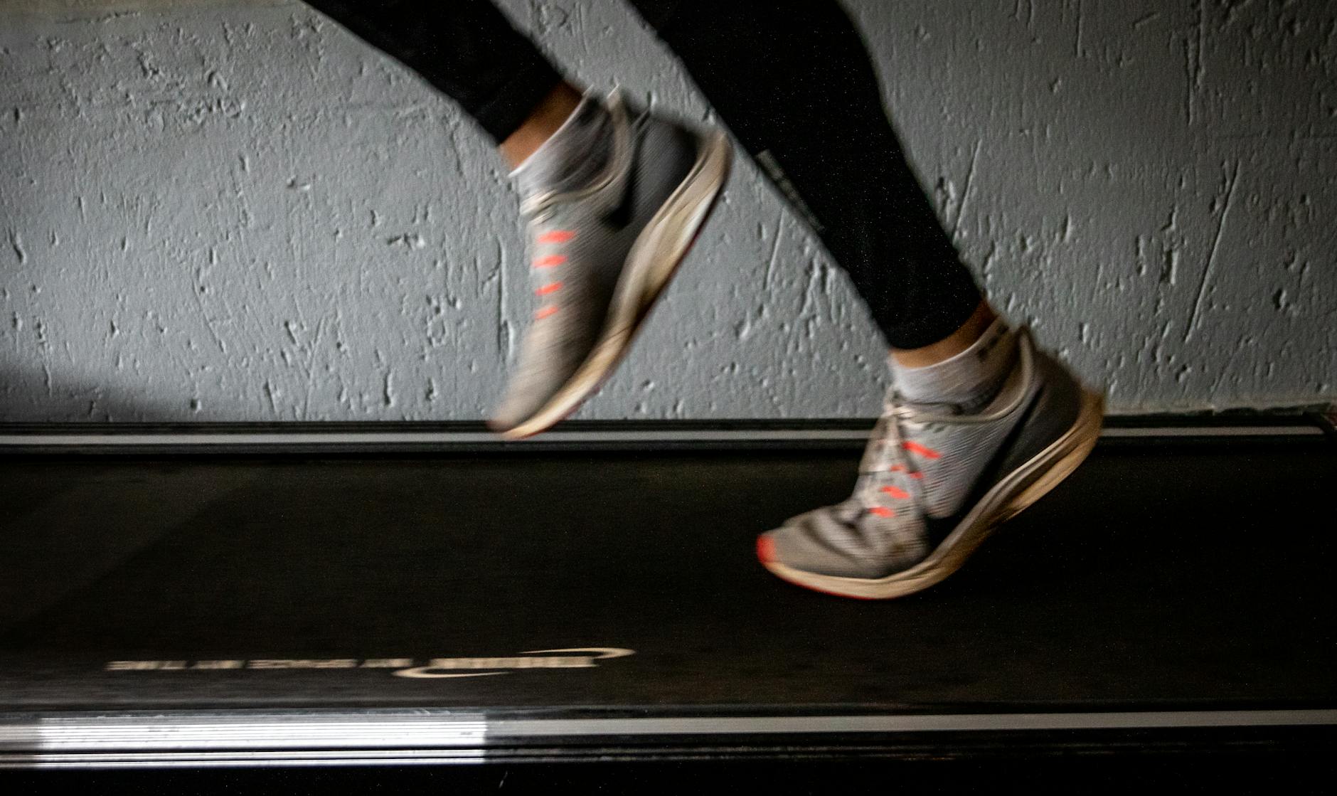Blurred image of a person running on a treadmill, conveying the speed and movement of high-intensity interval training