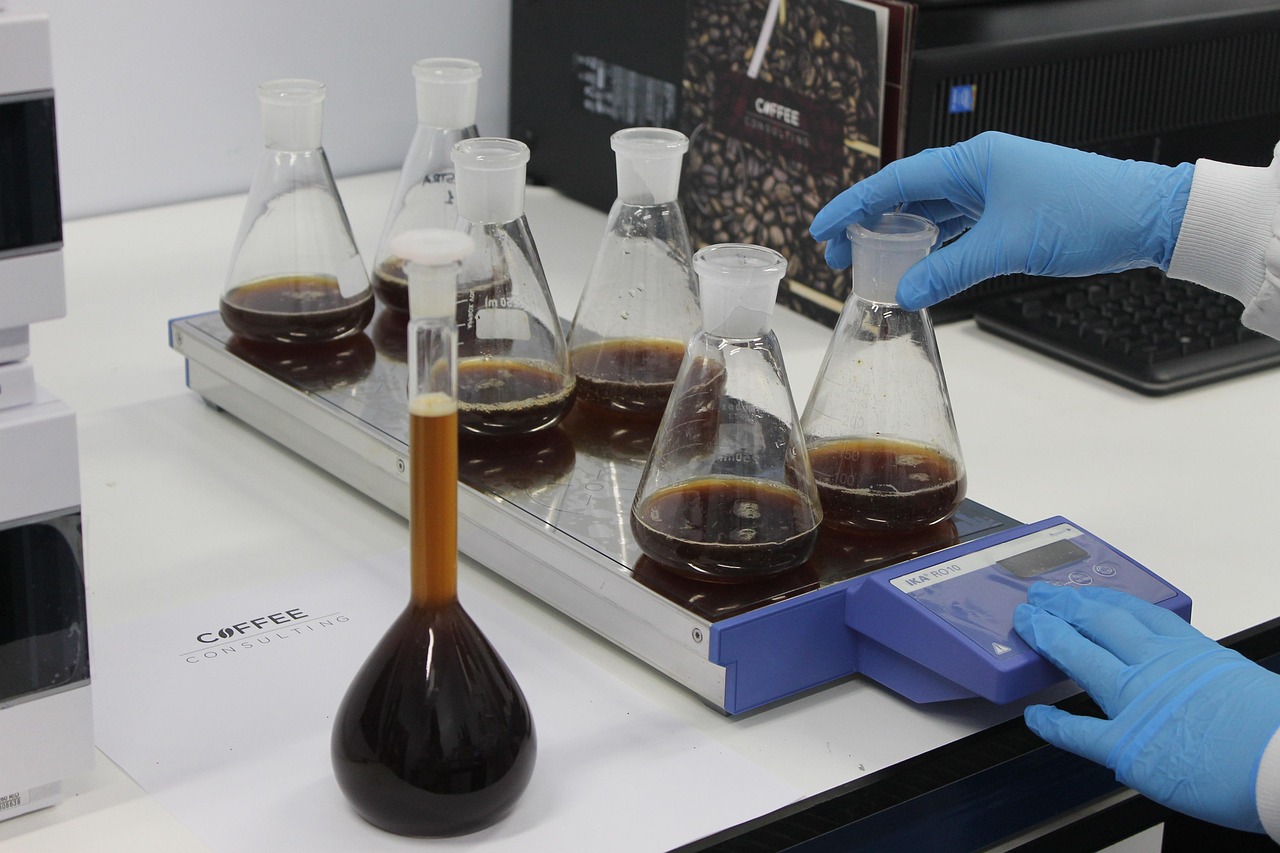 Laboratory glassware and coffee samples arranged for caffeine content analysis
