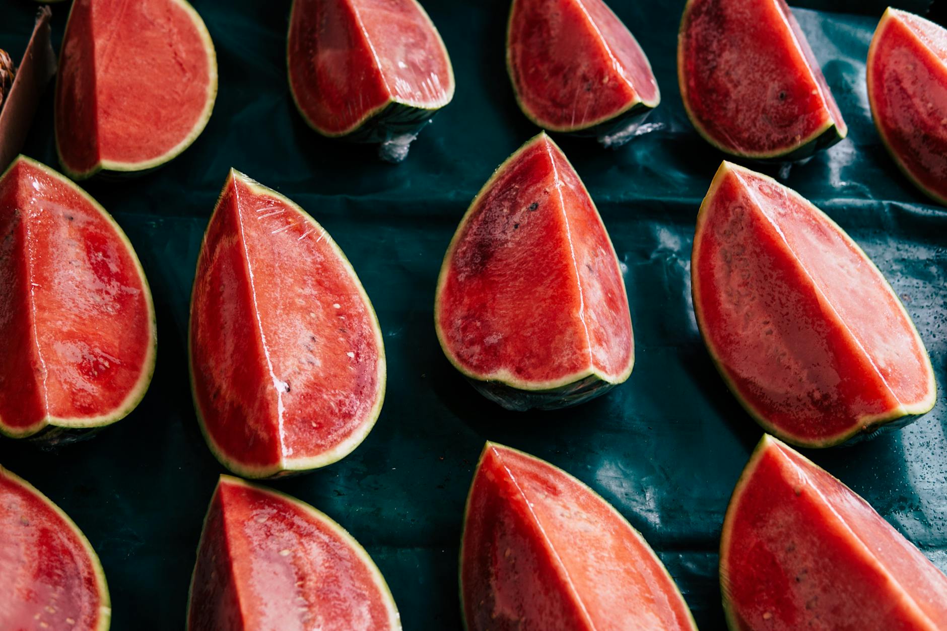 Watermelon slices and whole watermelon on a tabletop