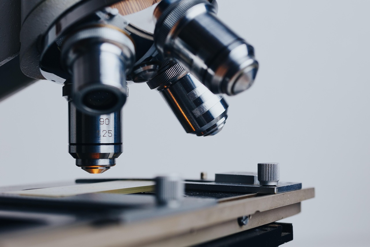 Laboratory microscope and test tubes illustrating thyroid research